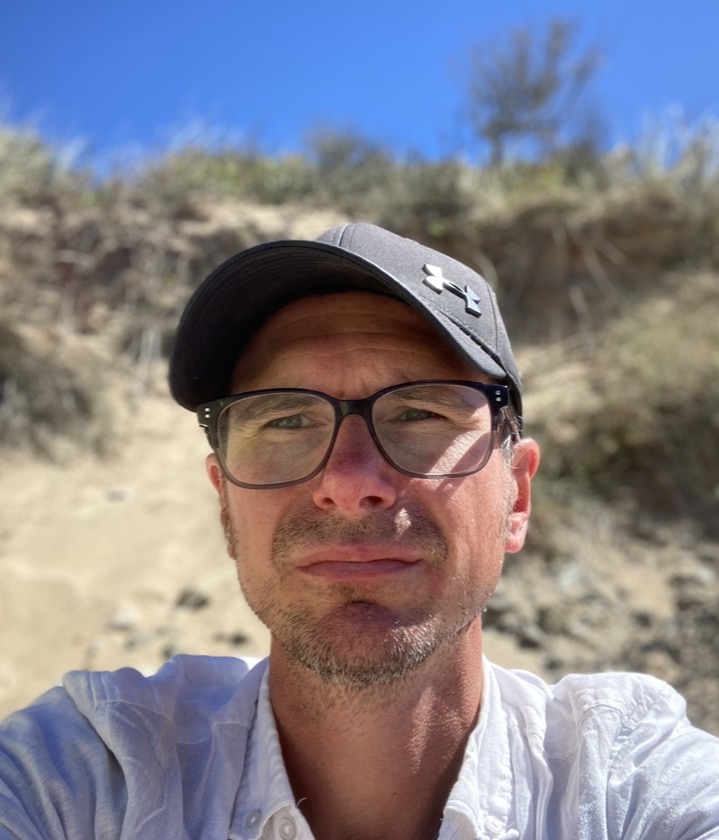 Martin Stewart outdoors in a cap and glasses